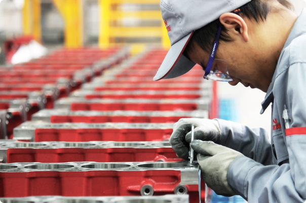 FOTON worker assembling engine components on a production line