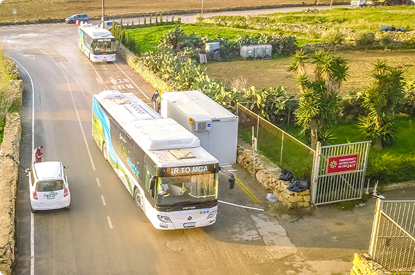 Aerial view of a FOTON bus and delivery trucks on a road